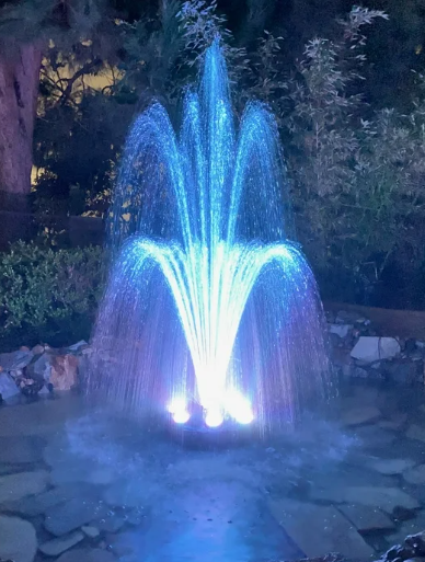 LED floating fountain water feature at night
