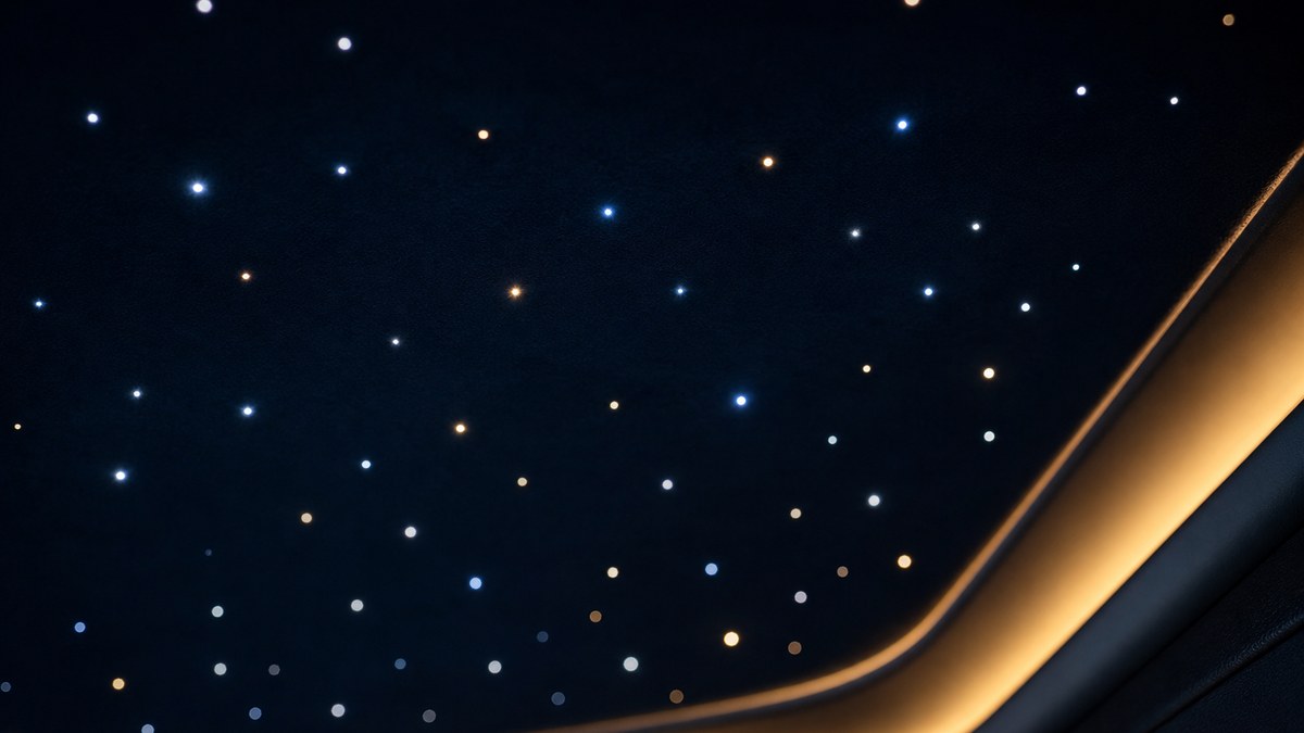 Close-up of fiber optic star tips glowing in a dark navy build-down ceiling panel next to a finished cove edge